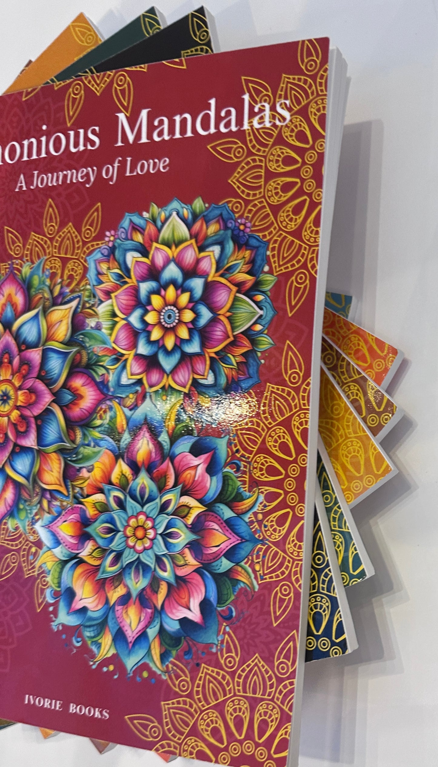 Harmonious Mandalas collection paperback books by Ivorie Books.
Stacked tabletop view of the Harmonious Mandalas collection by Ivorie Books, showing multiple paperback titles from the series together.